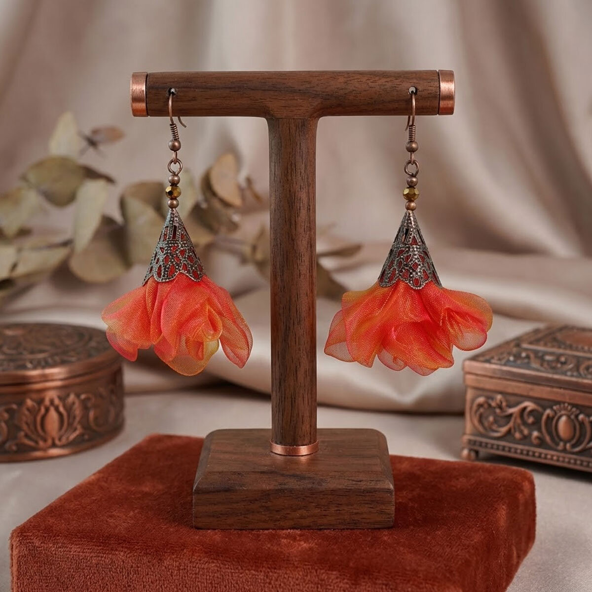 Długie pomarańczowo-różowe kolczyki kwiaty z miedzianym ażurowym elementem.