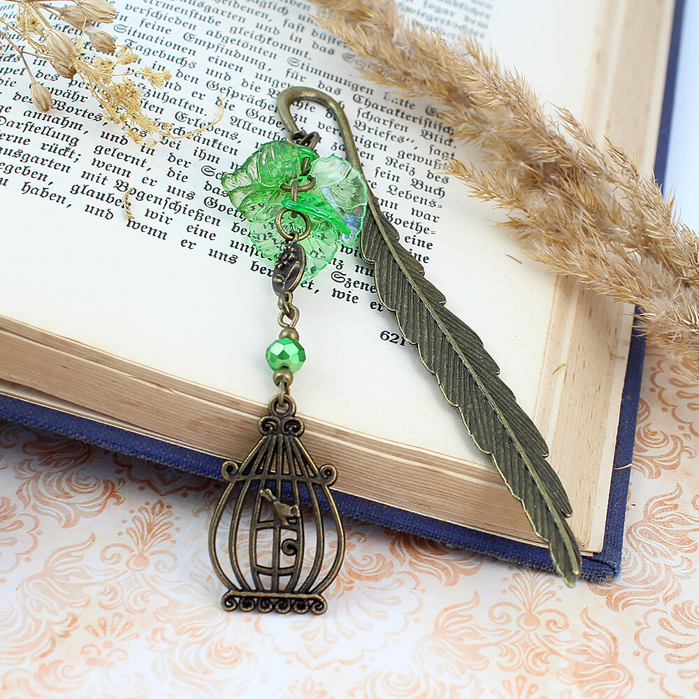 Zakładka do książki z antycznego brązu z zawieszką w kształcie ptaszka w klatce, akrylowymi listkami i szklanym koralikiem