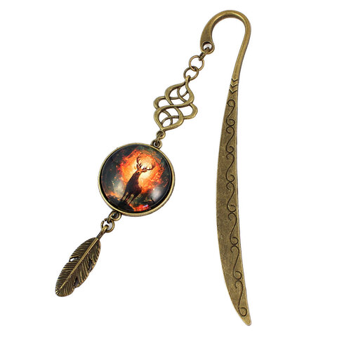 Zakładka do książki z antycznego brązu z ozdobnym falistym trzonem, zawieszką z piórkiem i ilustracją jelenia w ognistym lesie pod kaboszonem 